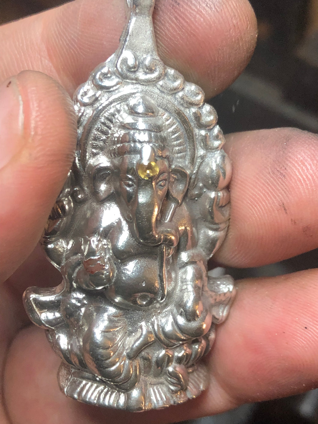 Sterling silver .925 Ganesh pendant with cast in place yellow and orange sapphire.