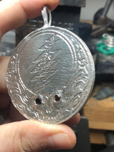 Load image into Gallery viewer, Sterling silver steal your face pendant with cast in place garnet eyes.
