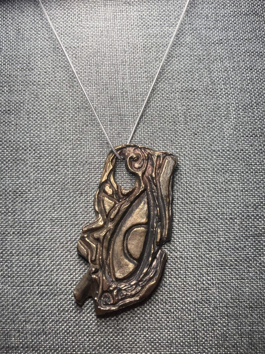 Eye of Horus pendant hand carved and cast in yellow bronze.
